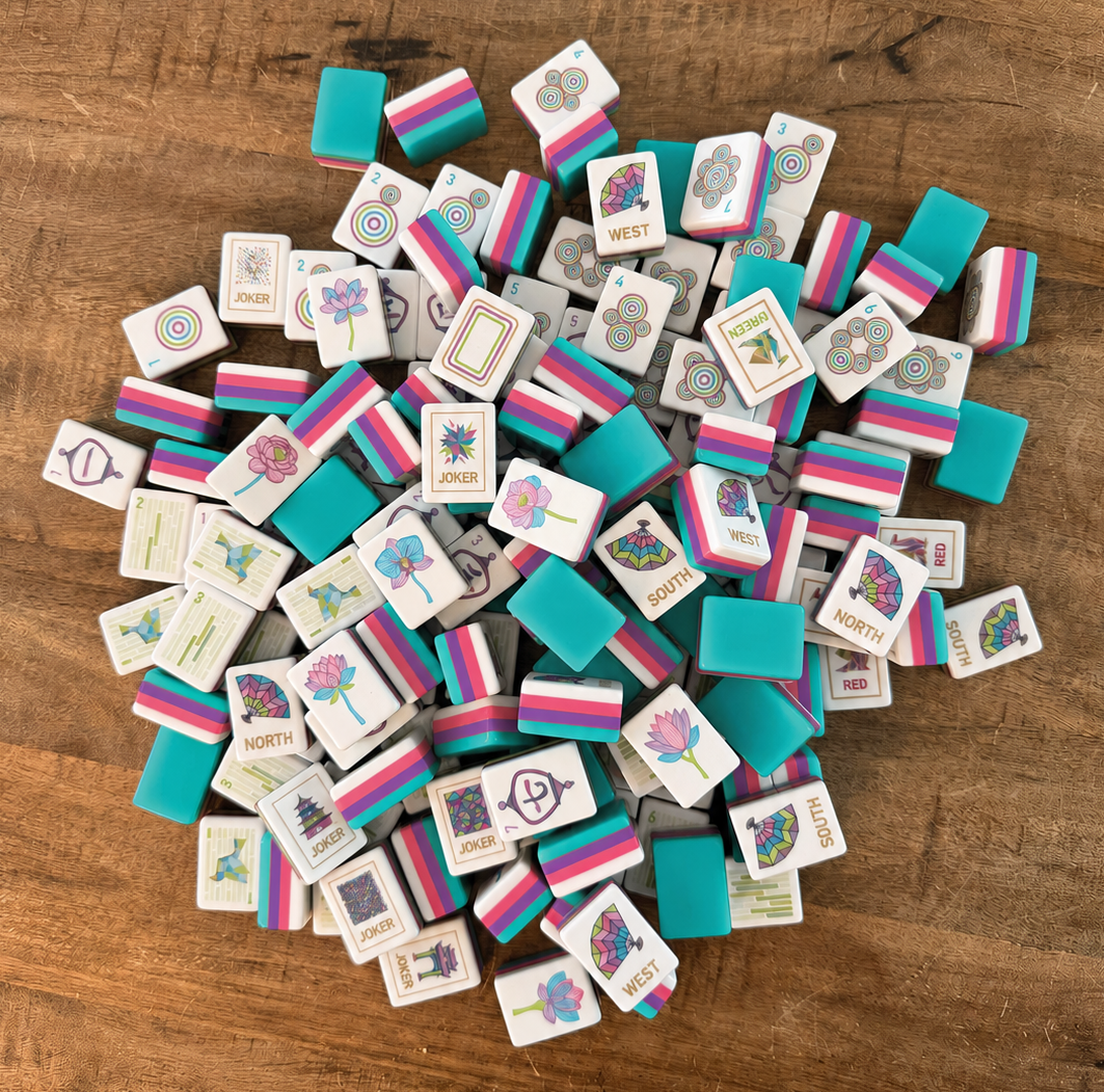 A pile of custom-designed mahjong tiles in jewel tones